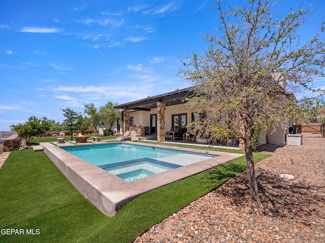 pool with a lawn, an in ground hot tub, a patio area, and french doors