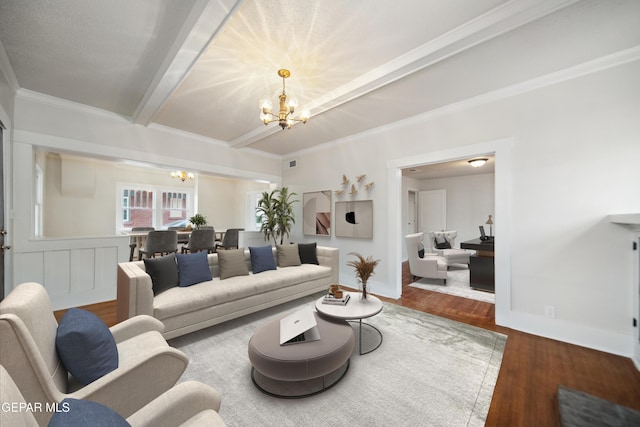 3217 Aurora Ave, El Paso, TX 79930 - living room featuring a chandelier, wood finished floors, ornamental molding, beamed ceiling, and baseboards