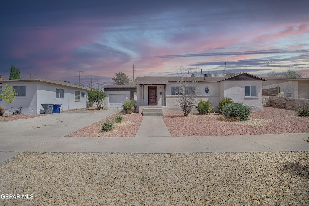 3222 N Stanton St, El Paso, TX 79902 - view of front of property with concrete driveway, stucco siding, and an attached garage