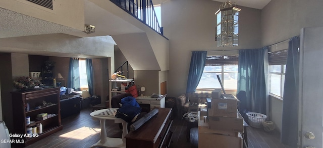 living area featuring high vaulted ceiling and wood finished floors