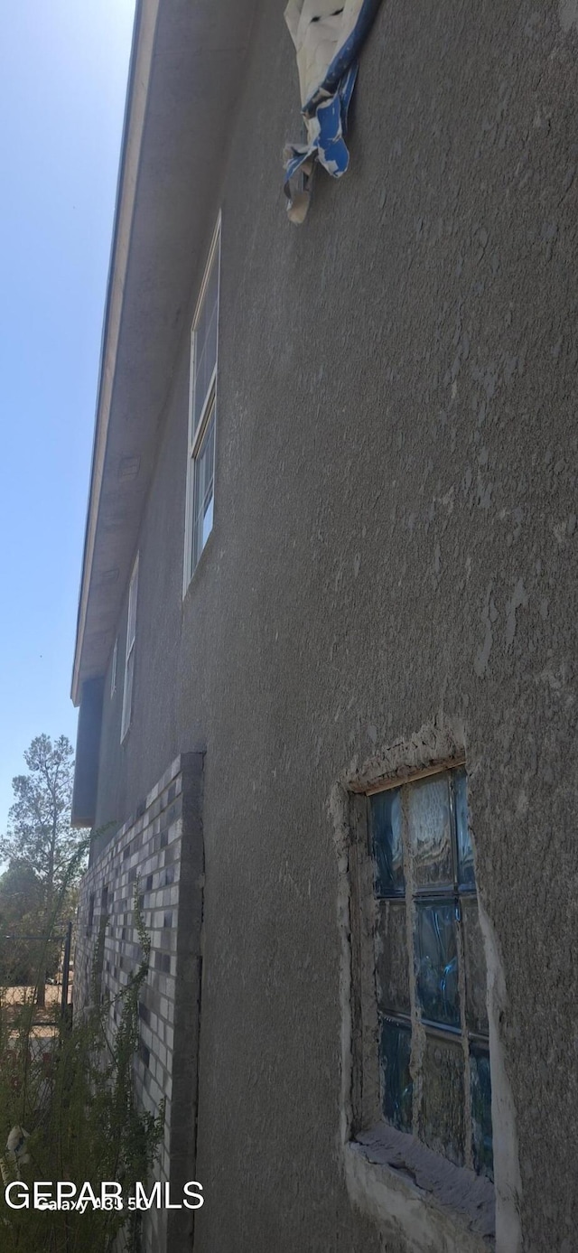 view of side of property featuring stucco siding