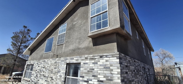 view of side of home with stucco siding