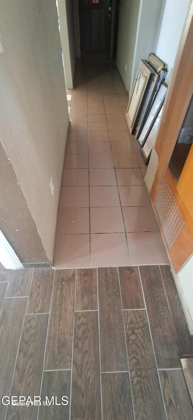 hallway with tile patterned floors