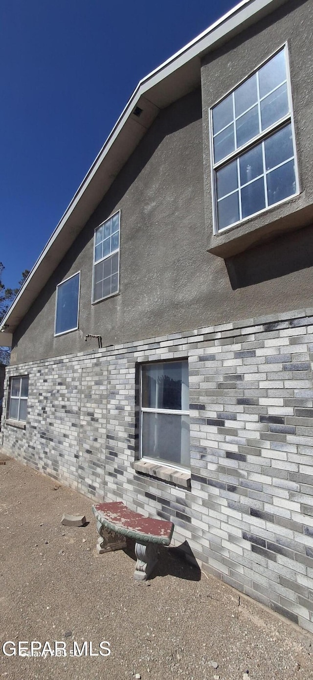 view of side of home featuring stucco siding