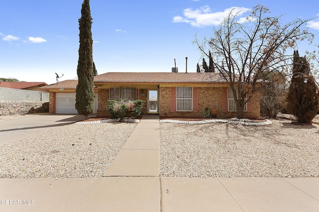 2816 Gaston Dr, El Paso, TX 79935 - view of front of property featuring concrete driveway, brick siding, and an attached garage
