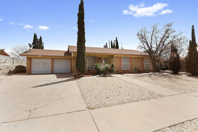 2816 Gaston Dr, El Paso, TX 79935 - ranch-style house featuring an attached garage, concrete driveway, and brick siding