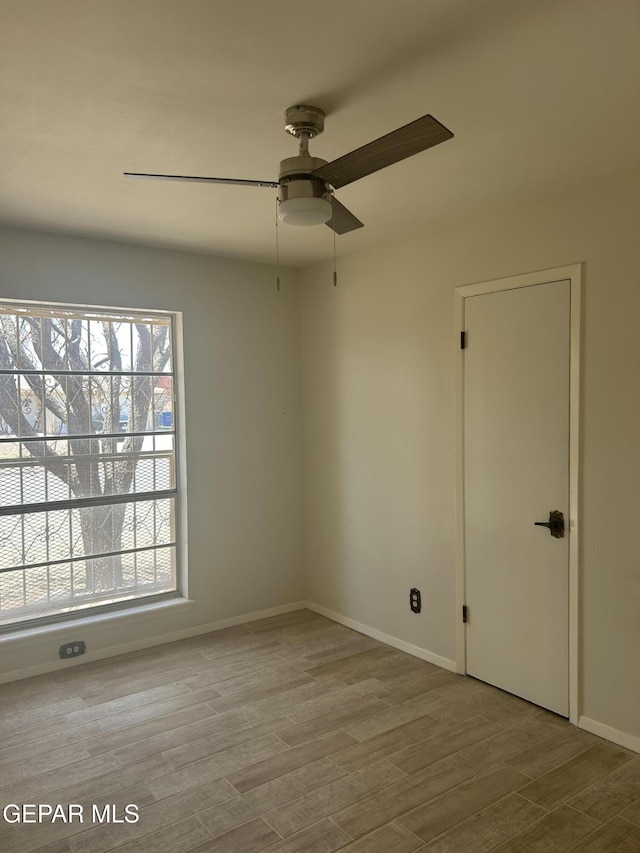 2816 Gaston Dr, El Paso, TX 79935 - unfurnished room with ceiling fan, wood finished floors, and baseboards