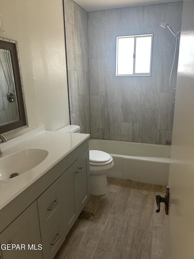 2816 Gaston Dr, El Paso, TX 79935 - full bathroom with vanity, wood finished floors, toilet, and shower / bath combination