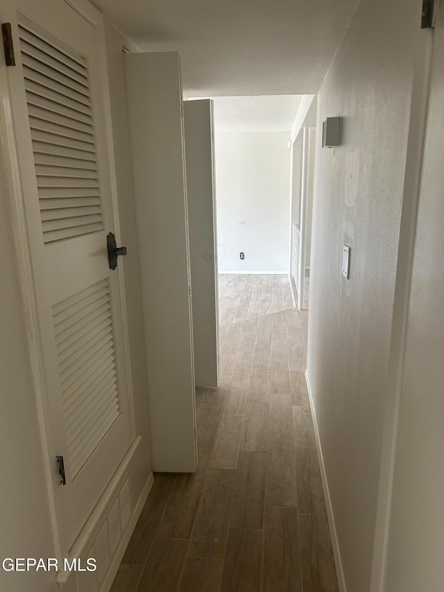 2816 Gaston Dr, El Paso, TX 79935 - hall featuring dark wood finished floors and baseboards