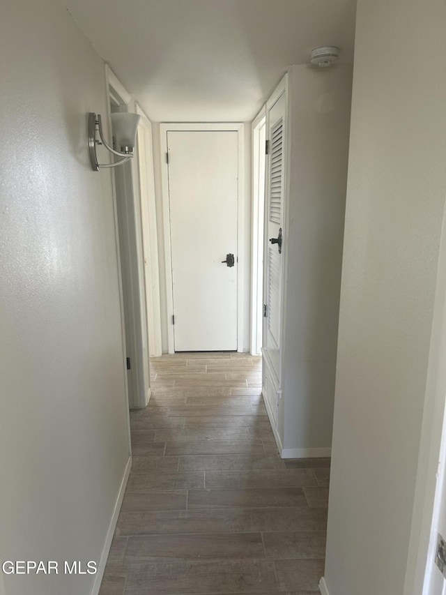 2816 Gaston Dr, El Paso, TX 79935 - hallway with baseboards and wood finished floors