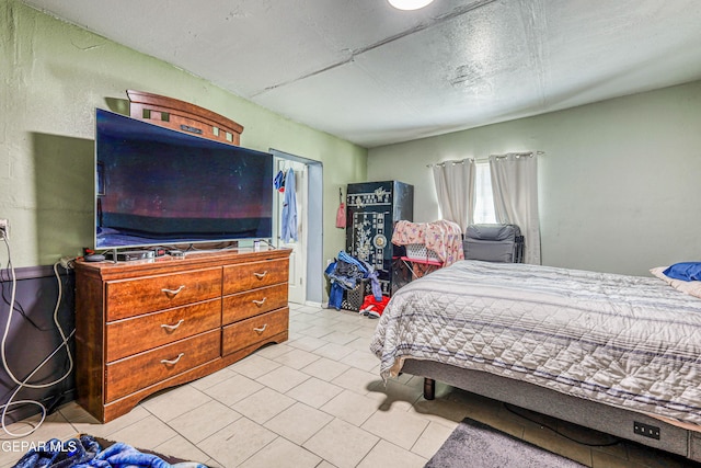 bedroom featuring light tile patterned floors