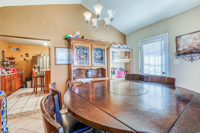 dining space with light tile patterned flooring, a notable chandelier, and lofted ceiling