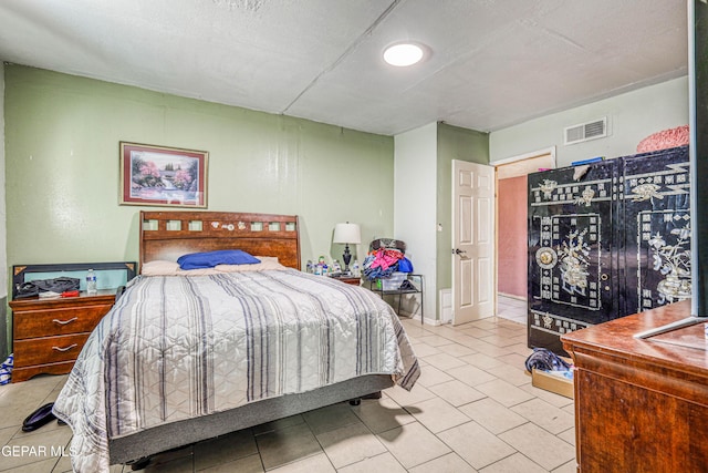 tiled bedroom with visible vents
