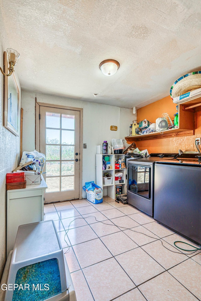 laundry room featuring light tile patterned floors and a textured ceiling