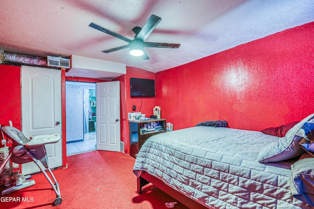 carpeted bedroom featuring visible vents, ceiling fan, a textured wall, and a textured ceiling