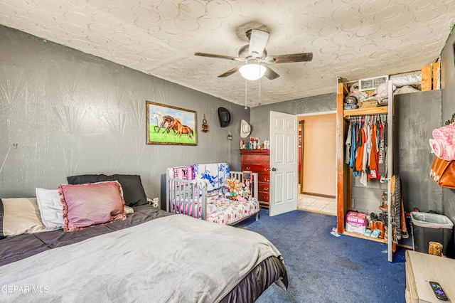 bedroom featuring ceiling fan, visible vents, and carpet floors