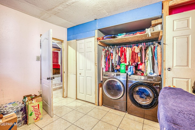 laundry room featuring light tile patterned floors, washer and clothes dryer, and laundry area