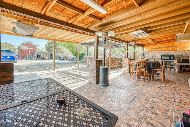 view of patio / terrace with a playground, fence, and outdoor dining area