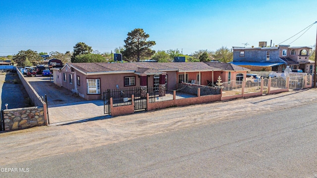 view of front of home featuring a fenced front yard and stucco siding