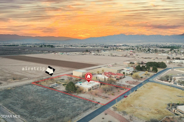 32 Cielo Dorado Dr, Anthony, NM 88021 - aerial view at dusk featuring a mountain view