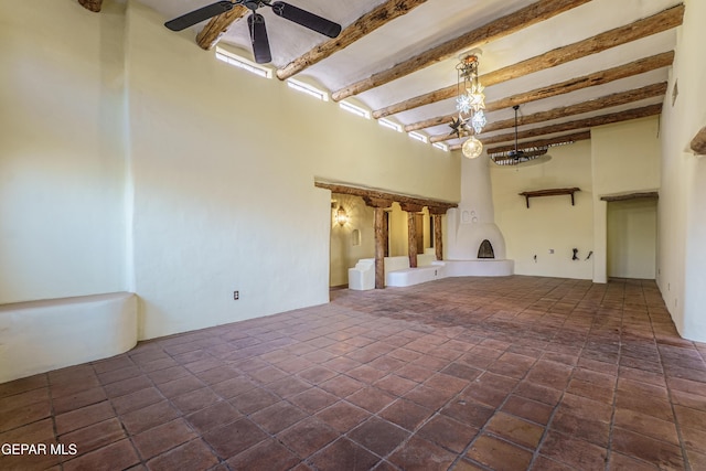 32 Cielo Dorado Dr, Anthony, NM 88021 - unfurnished living room with a towering ceiling, a ceiling fan, and beam ceiling