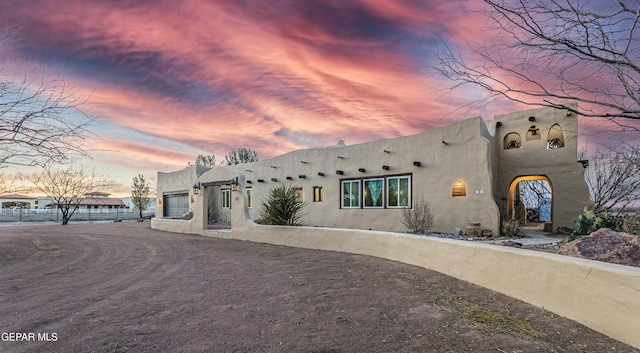 32 Cielo Dorado Dr, Anthony, NM 88021 - view of front facade with an attached garage and stucco siding