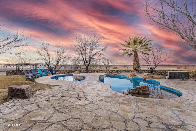 32 Cielo Dorado Dr, Anthony, NM 88021 - pool at dusk with a fenced in pool, a patio area, central air condition unit, and fence