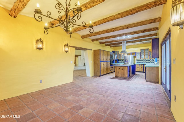 32 Cielo Dorado Dr, Anthony, NM 88021 - kitchen featuring decorative backsplash, a chandelier, stainless steel fridge with ice dispenser, and beamed ceiling