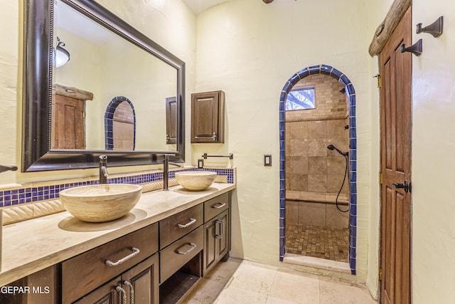 32 Cielo Dorado Dr, Anthony, NM 88021 - full bathroom featuring a sink, backsplash, tiled shower, and double vanity
