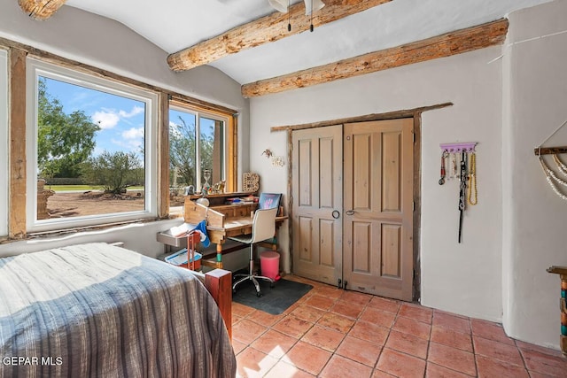 32 Cielo Dorado Dr, Anthony, NM 88021 - bedroom featuring light tile patterned floors, a closet, and vaulted ceiling with beams