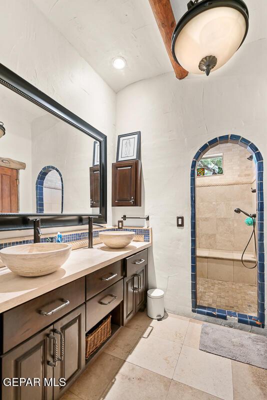 32 Cielo Dorado Dr, Anthony, NM 88021 - bathroom with a walk in shower, tile patterned flooring, double vanity, and a sink