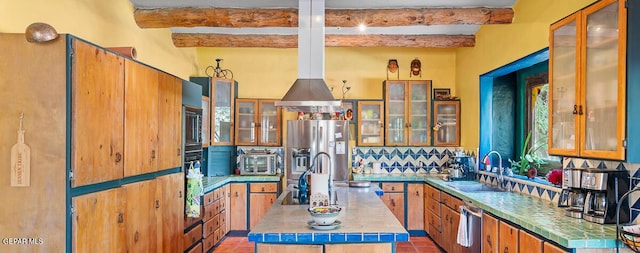 32 Cielo Dorado Dr, Anthony, NM 88021 - kitchen featuring glass insert cabinets, a center island, beam ceiling, stainless steel appliances, and a sink