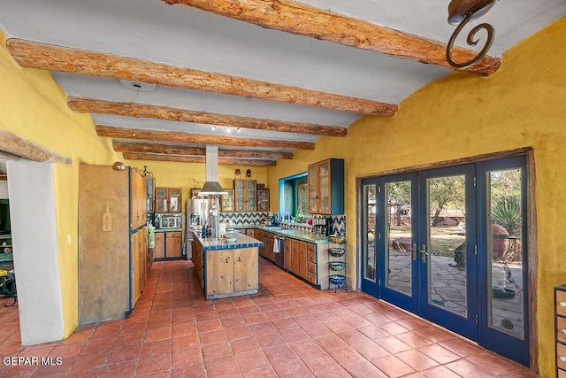 32 Cielo Dorado Dr, Anthony, NM 88021 - kitchen featuring beam ceiling, stainless steel appliances, french doors, a kitchen island, and extractor fan