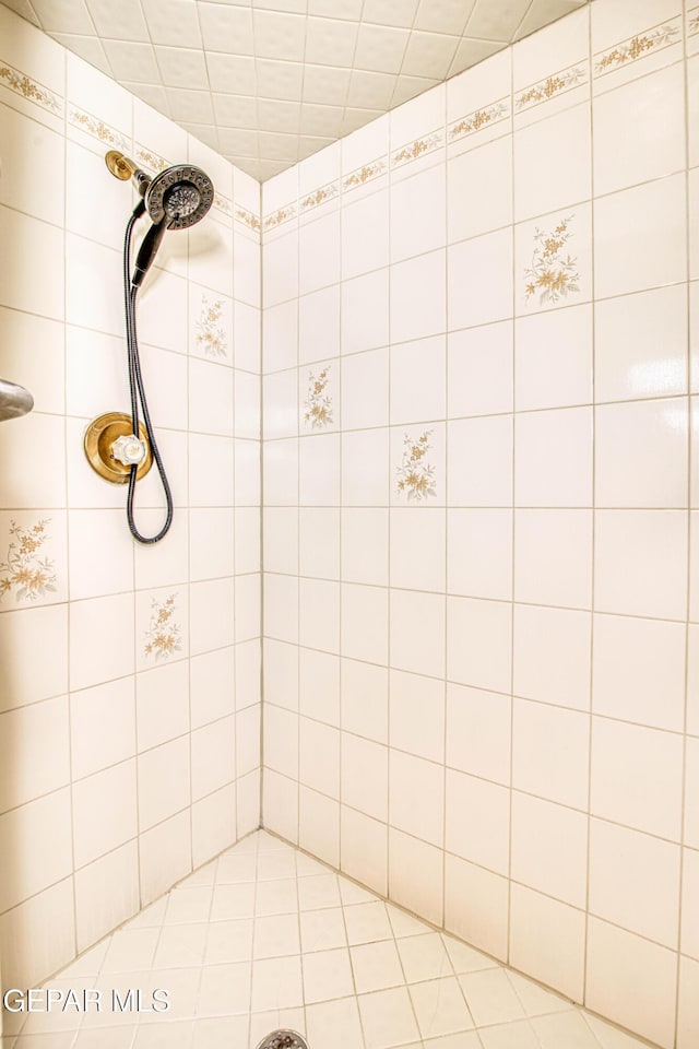 full bath with a tile shower