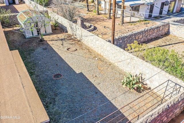 view of yard with fence and an outdoor structure