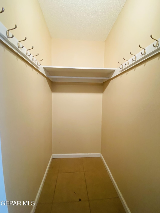 spacious closet featuring light tile patterned flooring