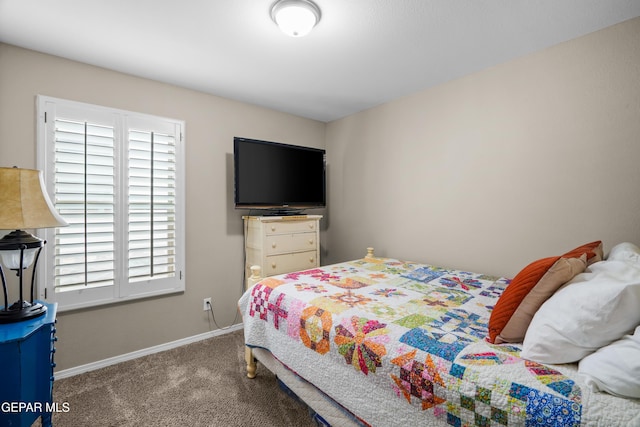bedroom featuring carpet and baseboards