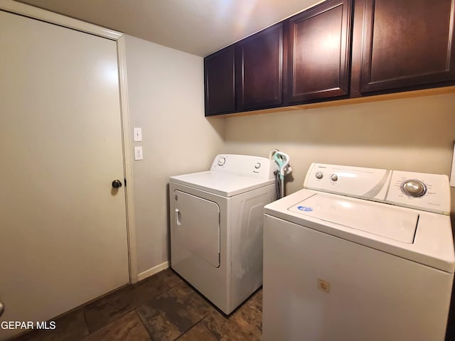 laundry room featuring separate washer and dryer and cabinet space