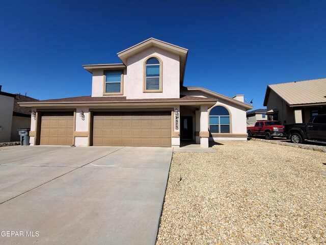 view of front of home featuring an attached garage, stucco siding, and concrete driveway
