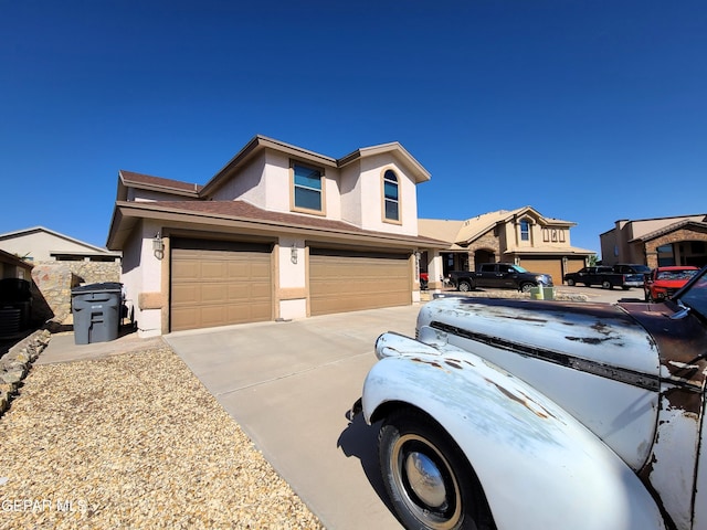 view of front of house featuring a garage, stucco siding, and concrete driveway