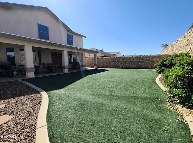 view of yard with a patio and a fenced backyard
