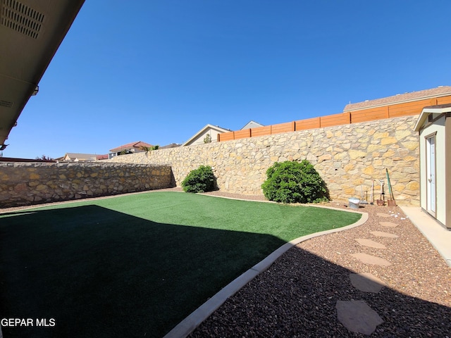 view of yard with a fenced backyard
