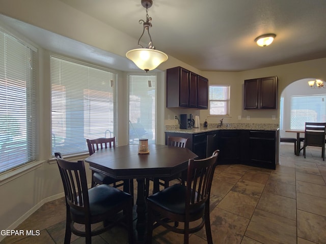 dining space featuring an inviting chandelier and baseboards
