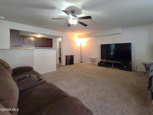 living area with light colored carpet and ceiling fan