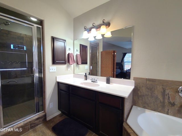 bathroom with vanity, lofted ceiling, a bath, and a shower stall