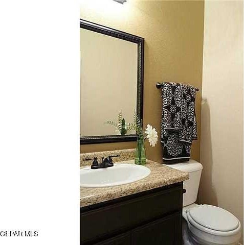 half bathroom with toilet and vanity