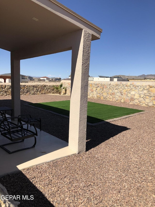 fenced backyard with a patio area