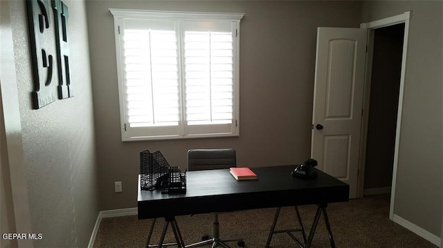 carpeted office space with baseboards