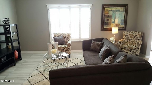 living area with healthy amount of natural light and baseboards