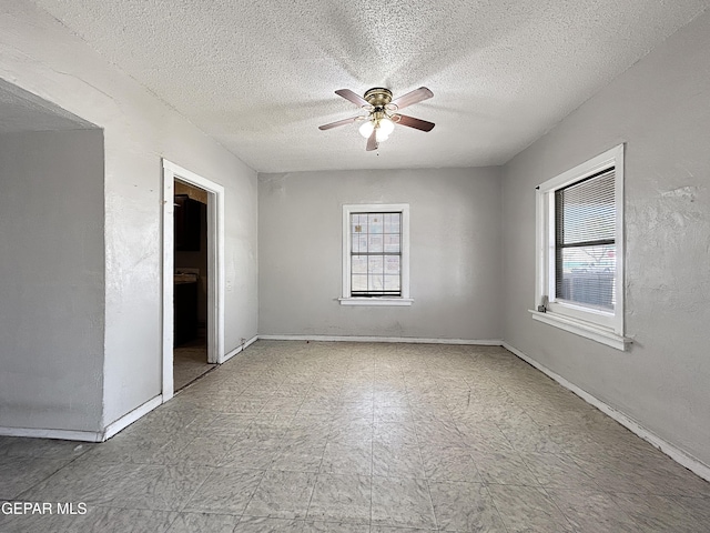 81 N Eucalyptus St, El Paso, TX 79901 - unfurnished bedroom with baseboards, tile patterned floors, multiple windows, and a ceiling fan